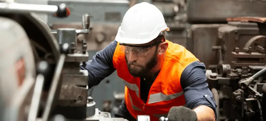 Male Manufacturing Engineer Operating Machinery at the Factory