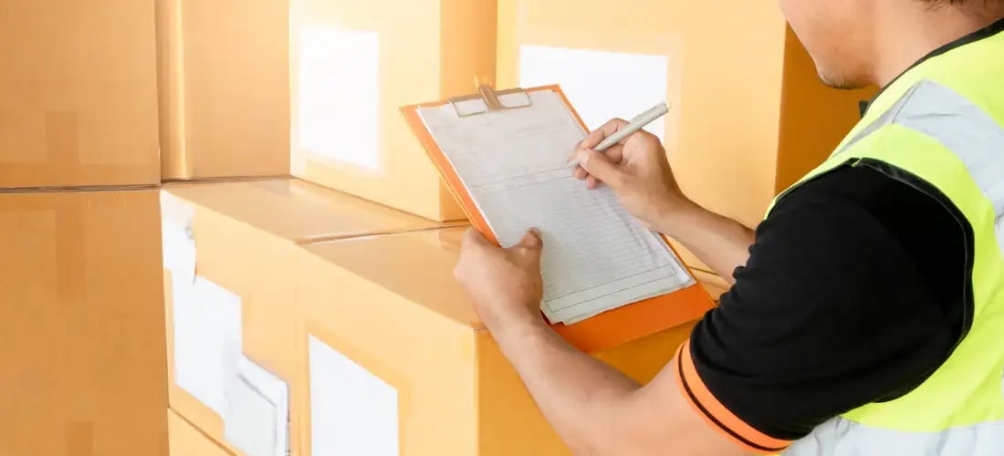 Warehouse worker taking inventory of a shipment