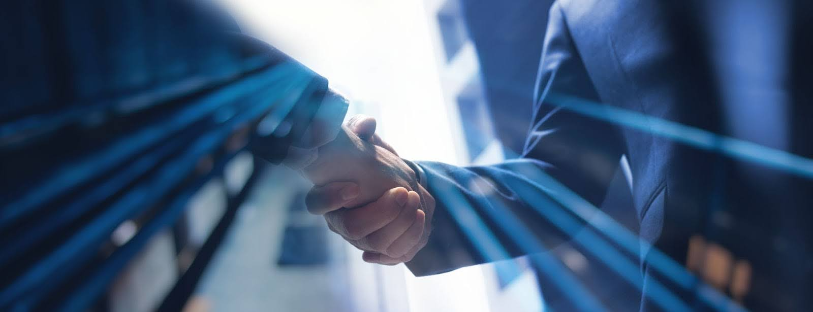 Handshake showing bBusiness-led M&A IT integration aligning technology strategy after a merger
